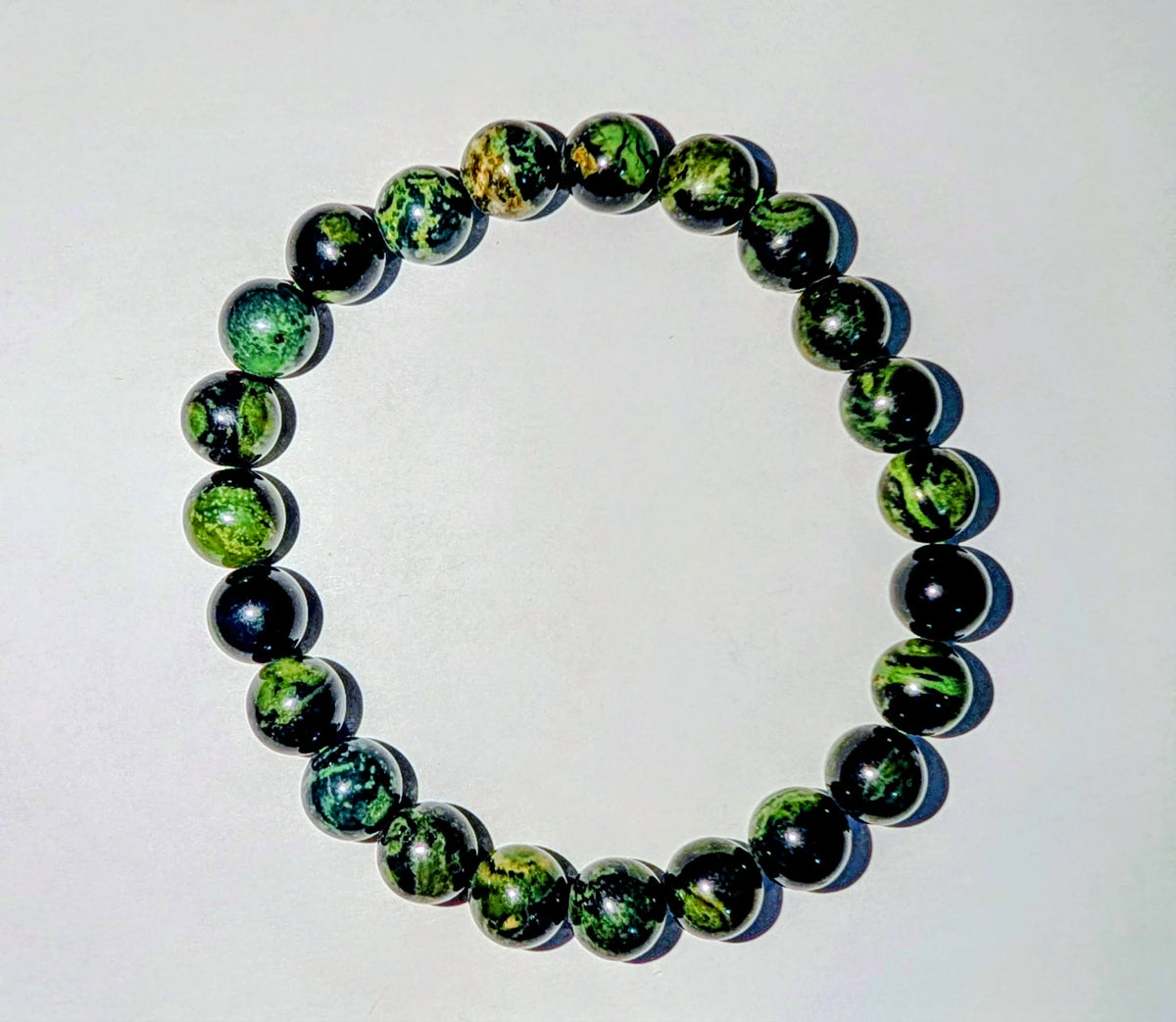 Kambaba Jasper genuine gemstone beaded bracelet featuring polished 8mm deep green beads with distinctive dark circular patterns.