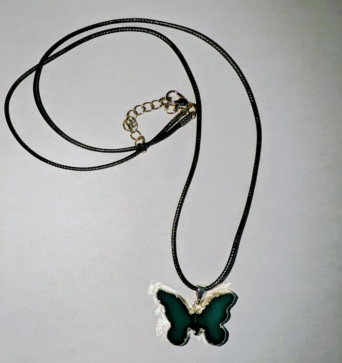 Silver-plated agate butterfly pendant featuring natural stone patterns with a 20-inch adjustable black cord necklace.